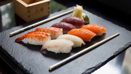 Set of sushi with variety of nigiris with fine fish like salmon and tuna.