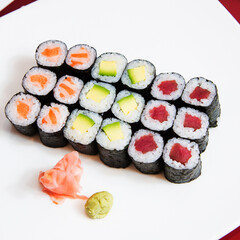 Uramaki and maki Sushi Set with different kinds of fish like tuna and salmon.