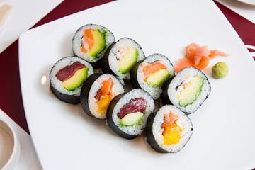 Uramaki and maki Sushi Set with different kinds of fish like tuna and salmon.