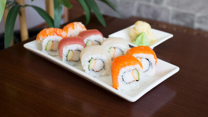 Uramaki and maki Sushi Set with different kinds of fish like tuna and salmon.