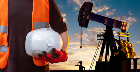 Oil derrick. Hand of man working on oil field. Helmet in hand of oil extractor. Employee petroleum...