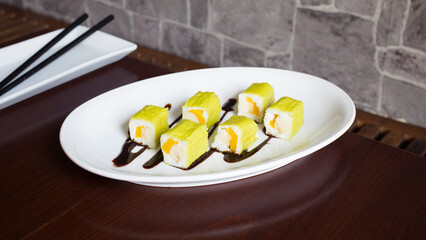 Vegan Maki sushi with rice and seaweed stuffed with vegetables and vegetarian ingredients.