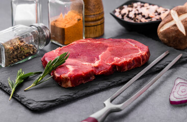 Fresh beef steak on a concrete background