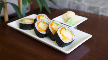 Vegan uramaki. Type of sushi covered with rice on the outside and filled with a combination of vegetables.