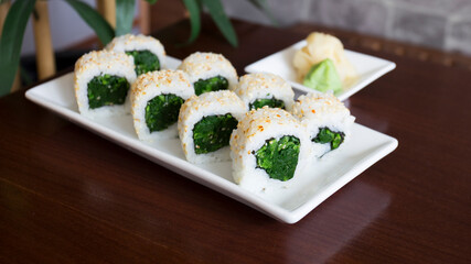 Vegan uramaki. Type of sushi covered with rice on the outside and filled with a combination of vegetables.