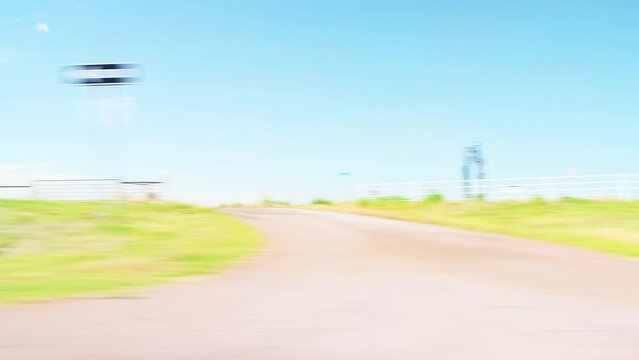 Interstate highway 82, Electra Texas with agricultural farm field on rural countryside road pov point of view vehicle shot