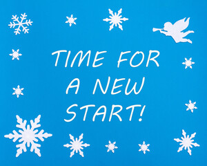 Text TIME FOR A NEW START on a blue background with Christmas snowflakes, a white angel. A new startup