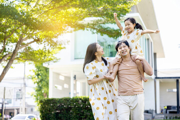 asian family Parents and daughters doing a happy walk in the village garden. During the holidays weekends to relax. friendship and living together. member health care. Concept health insurance