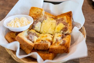 Pork and cheese buns on a white paper