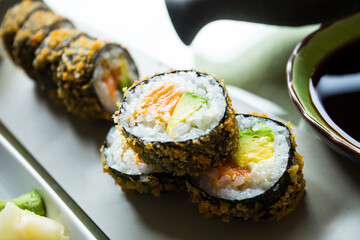 Salmon hot roll. Sushi roll stuffed with salmon and fried whole with breadcrumbs.