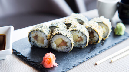 Salmon hot roll. Sushi roll stuffed with salmon and fried whole with breadcrumbs.