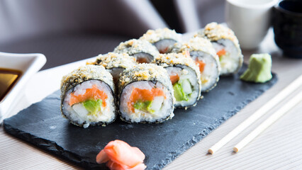 Salmon hot roll. Sushi roll stuffed with salmon and fried whole with breadcrumbs.