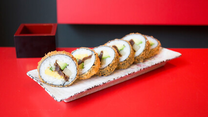 Vegan sushi hot roll. Sushi roll filled with vegetables and fried.