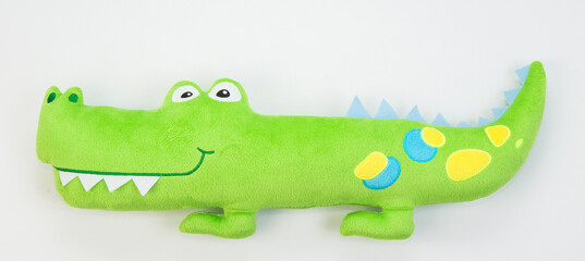 Plush green crocodile.Children's soft toy for children on a white background.