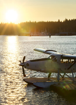 Floatplane along a dock a sunset; Vancouver, British Columbia, Canada