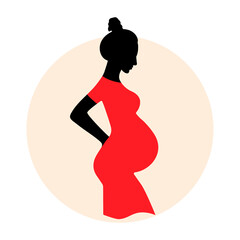 Silhouette of a pregnant woman in a bright red dress.