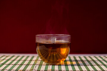 cup of tea on a table with tablecloth