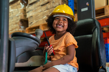 Fototapeta na wymiar three-year-old African-American girl in an engineer's helmet smiling happily drives a forklift as an engineer in a factory.
