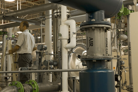 Engineer with air compressors in water treatment plant