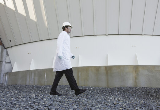 Inspector walking near the base of a digester in a water treatment plant