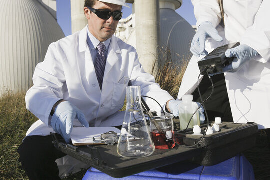 Two scientists experimenting with a water sample