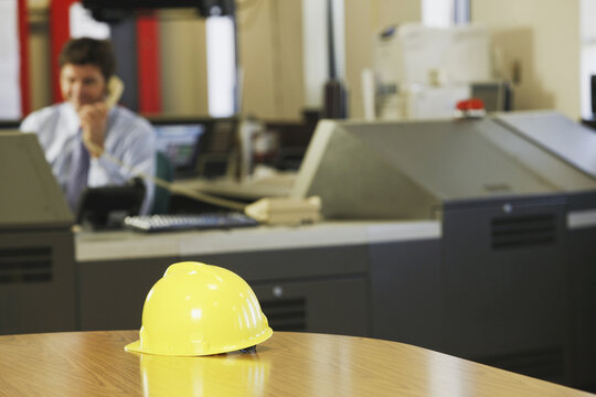 Hardhat on a table in a control room