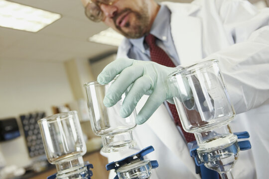 Scientist filtering a sample