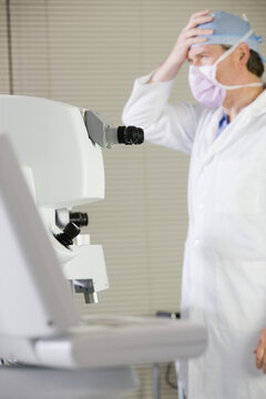 Doctor standing in front of a laser machine