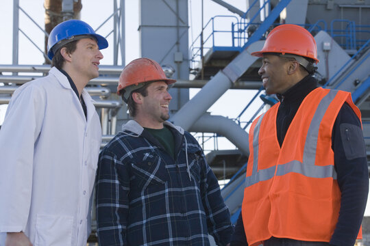 Lab worker with two engineers at an asphalt plant