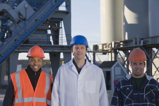 Lab worker with two engineers at an asphalt plant