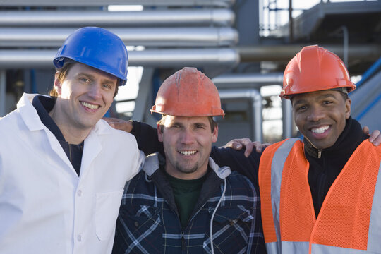 Lab worker with two engineers at an asphalt plant