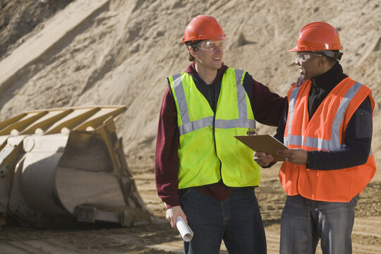 Two engineers discussing at a construction site