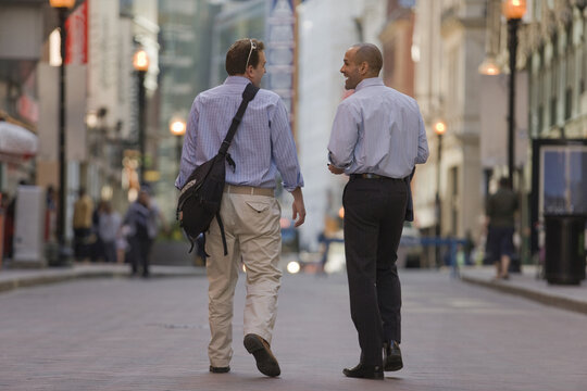 Two men walking together in a street