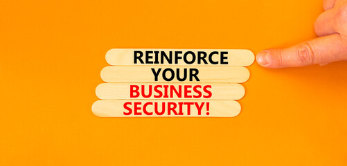 Reinforce your business security symbol. Concept word Reinforce your business security on sticks. Beautiful orange background. Business reinforce your business security concept. Copy space.