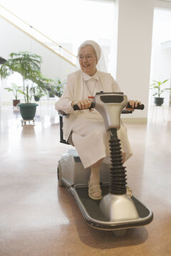 Nun riding a motorized wheelchair