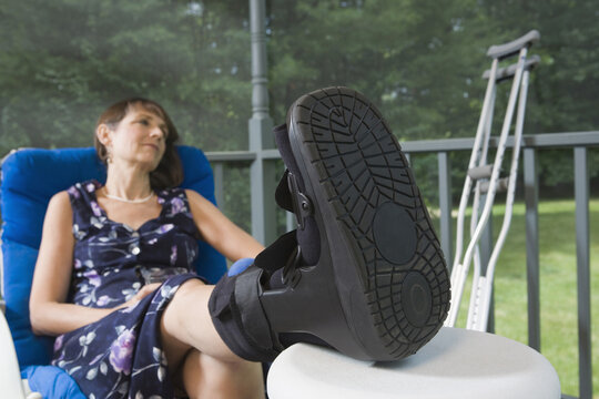 Middle-aged disabled woman sitting on a chair