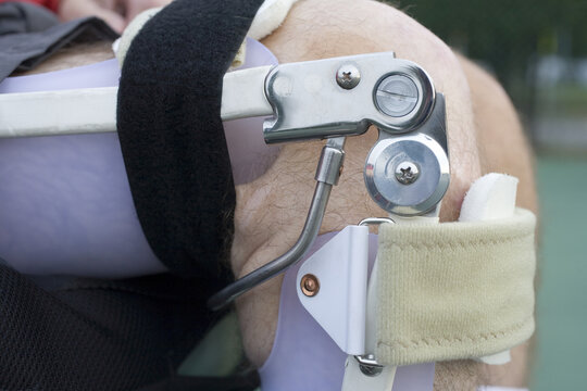 Mid section view of a man wearing leg brace.
