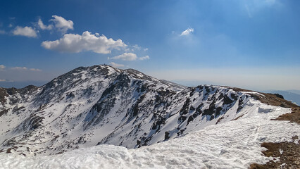 Panoramic view on the meteorological station at the snow covered summit peak of Zirbitzkogel, Seetal Alps, Styria (Steiermark), Austria, Europe. Idyllic hiking trail on sunny early spring day