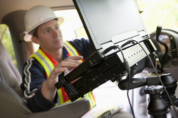 Inspector using a laptop in a vehicle