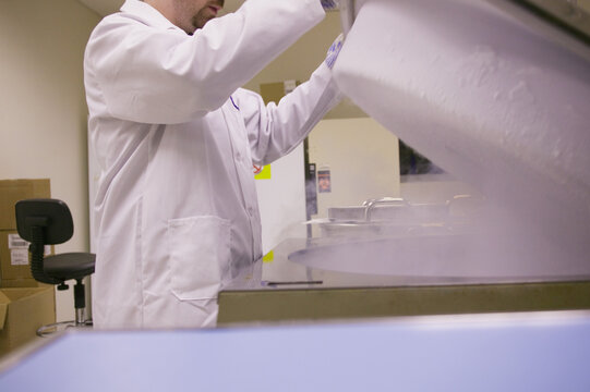Scientist working on a liquid nitrogen container
