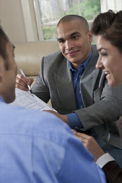 Young professionals working together at a table reviewing documents