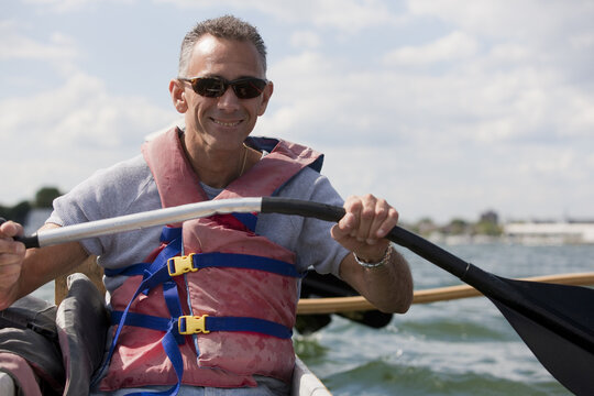 Man With Spinal Cord Injury Outrigger Canoeing In The Sea