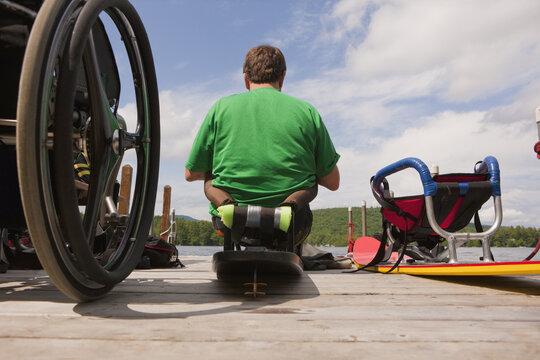 Disabled Athlete With A Water Ski Board On A Dock