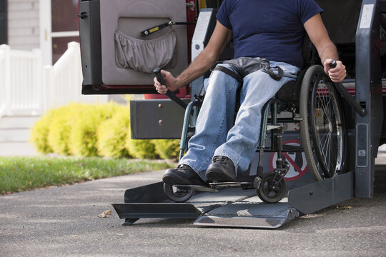 Man with spinal cord injury in a wheelchair getting in his accessible van