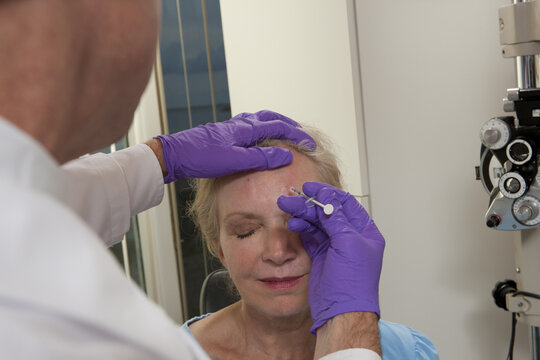 Ophthalmologist giving a Botox injection to a patient