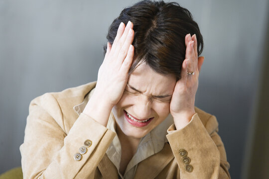 Business woman crying in pain.
