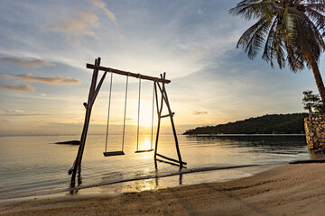 Swing on the beach at sunset, Thailand