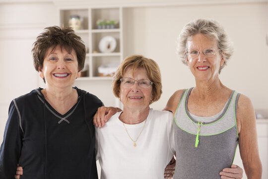 Portrait of three senior friends smiling after exercise class