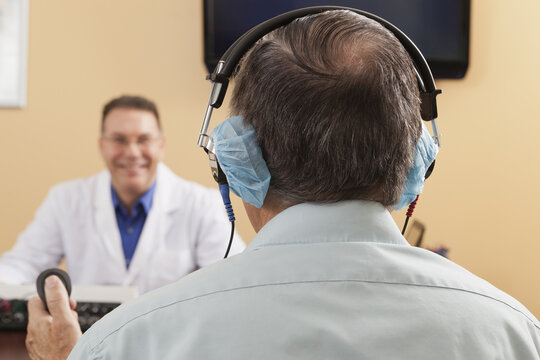 Patient using response button during audiometric evaluation