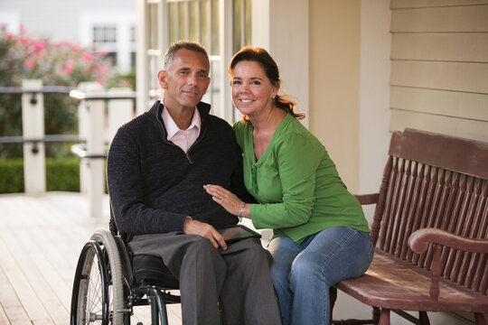 Portrait of a happy couple with him in a wheelchair